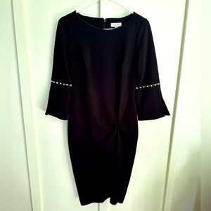 Calvin Klein beautiful black dress! Size 4. Pearl beads on sleeve. Gently worn